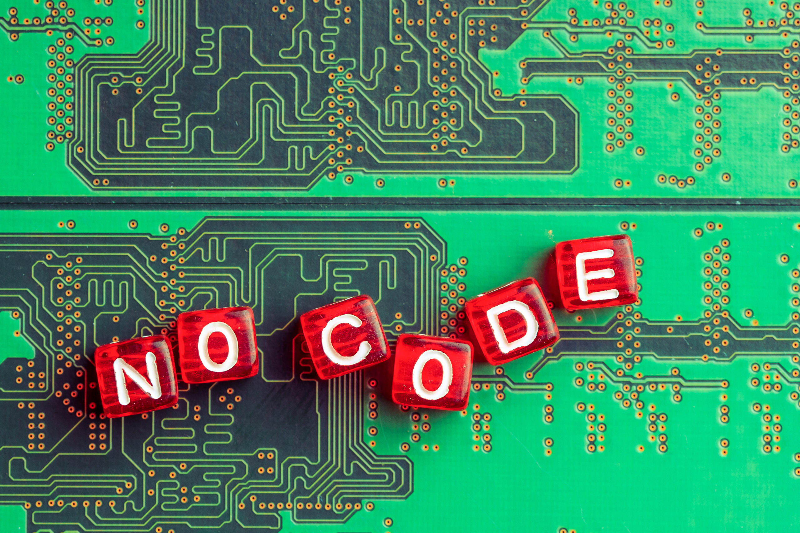 Illustration of 'No Code' on a circuit board background, representing the rise of low code and no code platforms in software development, enabling automation, faster workflows, and simplified digital transformation for businesses.
